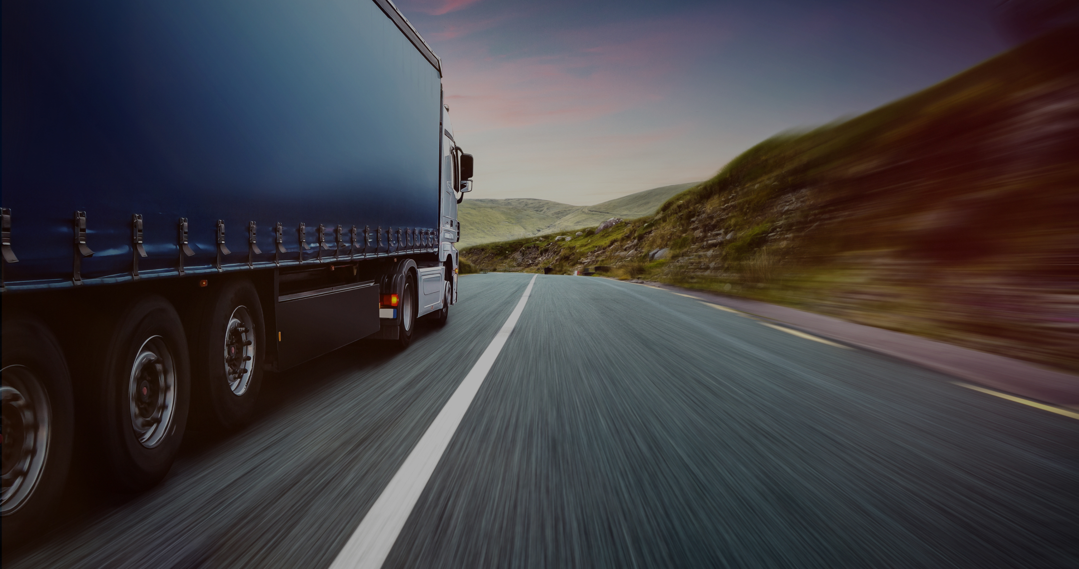 A picture of a truck driving on a road