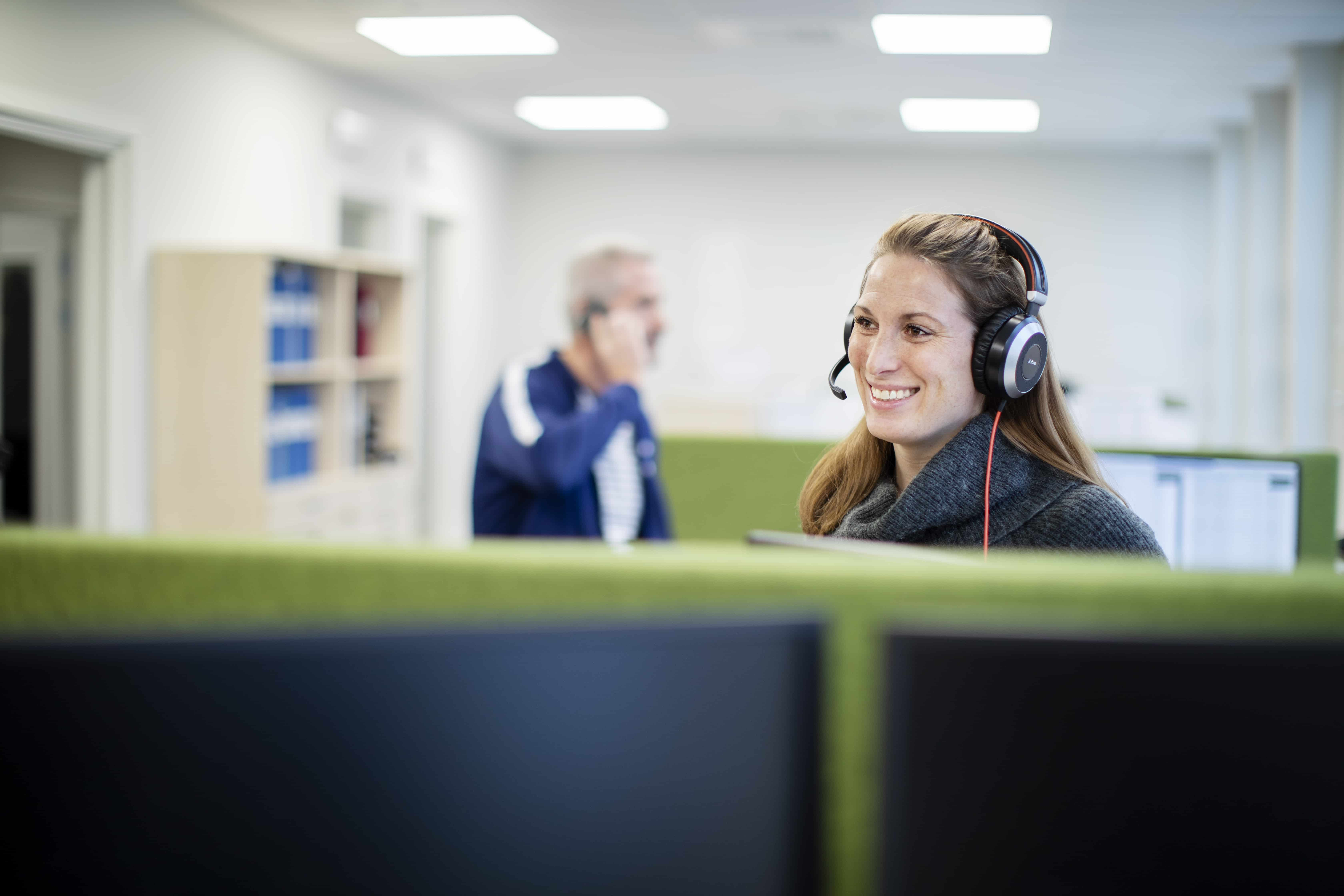 Sales coordinators talking in telephones with customer